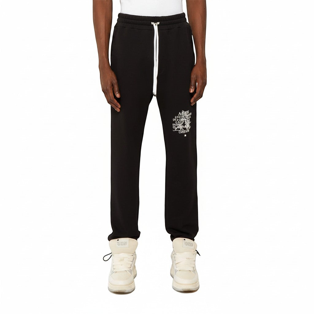 Pantalones de chándal negros AMIRI Precious Memories de The Hype Company con cordón blanco y estampado gráfico.