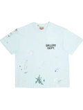 Camiseta The Hype Company GALLERY DEPT en azul claro con estampado de salpicaduras de pintura y logo en el pecho