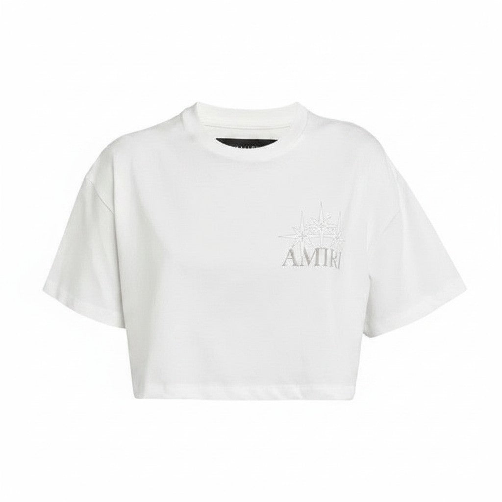Camiseta corta blanca de The Hype Company con estampado de estrella plateada y logo de AMIRI.