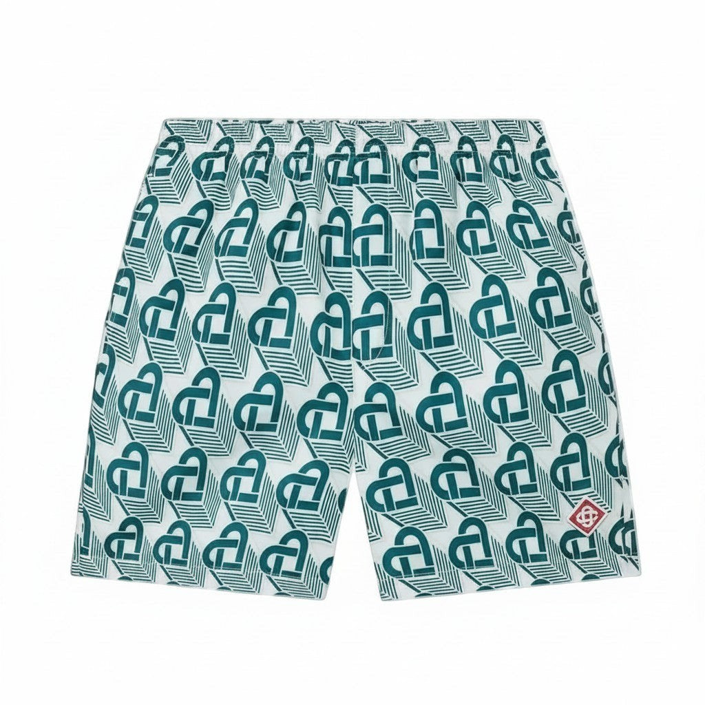 The Hype Company green monogram swim shorts with a white background and a repeating pattern of interlocking green shapes.