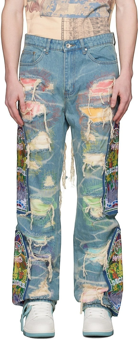 Vaqueros The Hype Company WHO DECIDES WAR ROYGBIV FUSION con efecto desgastado, parches coloridos y bordados detallados